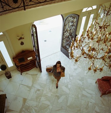 Woman with luggage, walking into hotel, elevated view