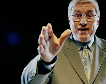 Mature man giving speech, gesturing with hand