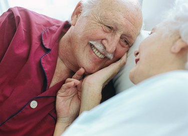 portrait of a mature couple lying in bed together 