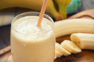 Fresh made Banana smoothie on wooden background