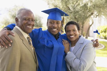 Portrait of a Young Man With His Arm Around His Mother and Father at Graduation