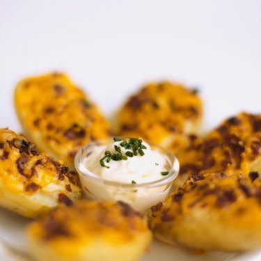 Close-up of potato skins and sour cream dip