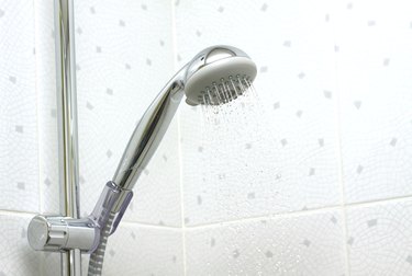 Shower in bathroom with running water down