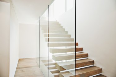 Floating staircase and glass walls in modern house