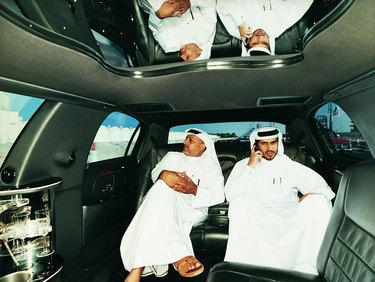 Two Businessmen in Traditional Middle Eastern Dress Sitting in the Back Seat of a Limousine