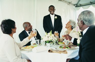 Young Man Standing to Give a Speech at a Wedding Reception