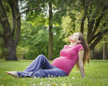 Beautiful pregnant woman in the park