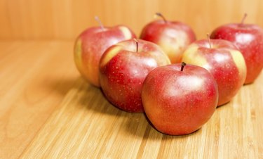 Fresh red apples on a wooden background