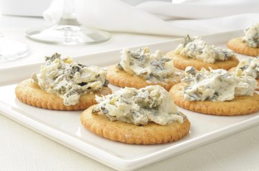 Crackers with spinach artichoke spread