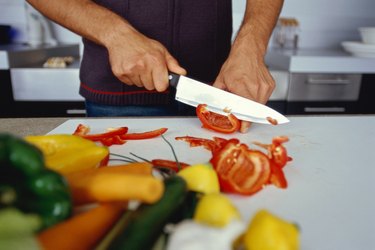 view of a person slicing tomatoes