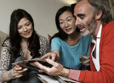 Three friends looking at records together