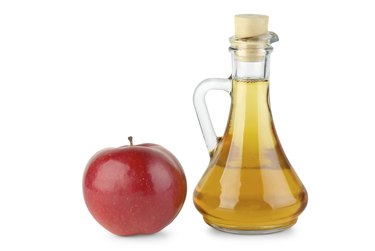 Decanter with vinegar and red apple