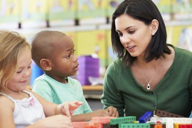 Elementary Pupils Counting With Teacher In Classroom