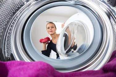 Young woman doing laundry