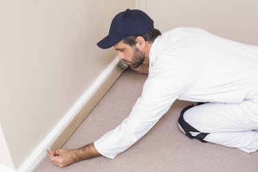 Handyman laying down a carpet