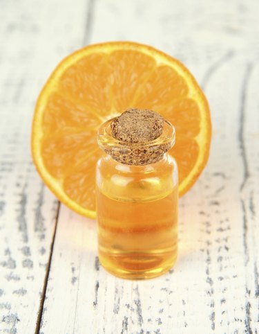 Tangerine essential oil and tangerine on wooden table