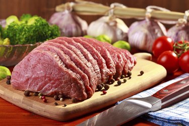 Raw beef and vegetables on wood