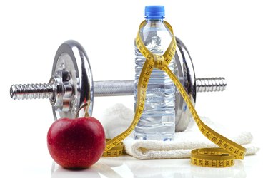 Metal dumbell with red apple and bottle