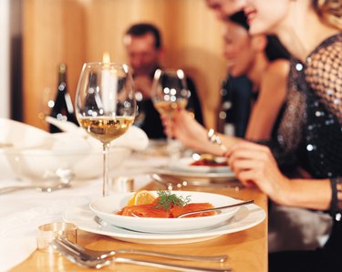 Close-up of dinner setting with salmon and wine