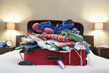 Open suitcase on bed