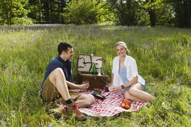 Couple having picnic in field