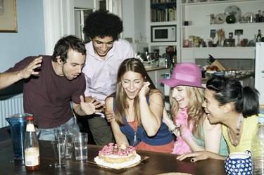 Group of friends admiring cake