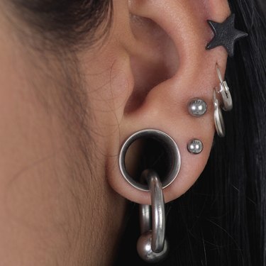 Extreme close-up of person's pierced ear