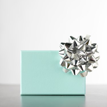 Gift box decorated with silver rosette, close-up