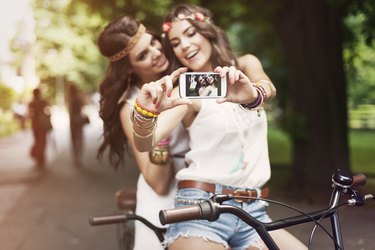 Hippie girls taking selfie at park