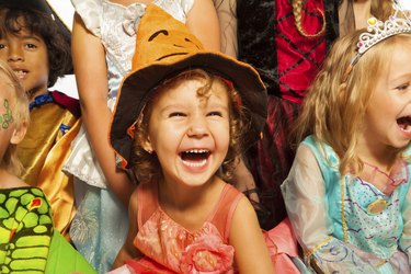 Laughing girl in Halloween costume with friends