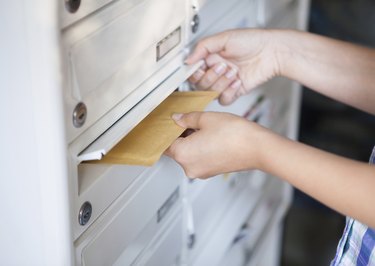 Woman putting envelope in mailbox