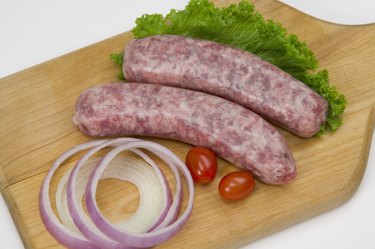 Uncooked bratwurst on a cutting board
