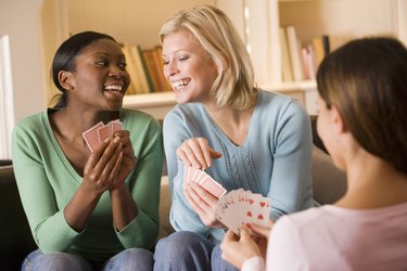 Smiling women playing cards