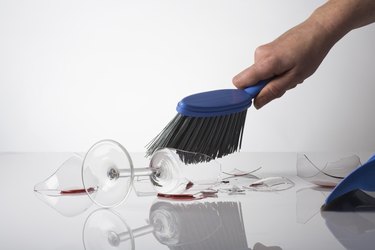 Person cleaning up broken glass