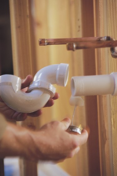 Man connecting PVC pipes