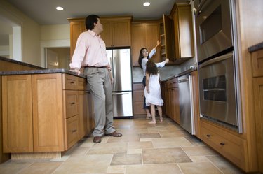 Family inspecting kitchen in house for sale