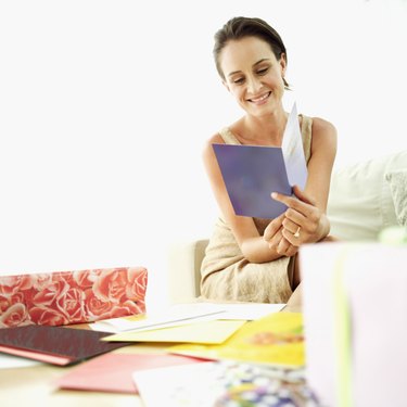 Young woman reading a greeting card