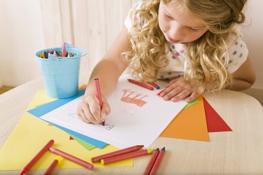 Child drawing at table