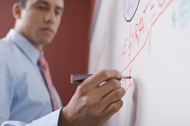 Businessman writing on board