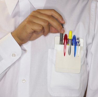 Man placing pen in shirt pocket