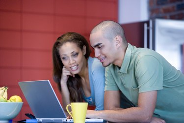 African American couple looking at laptop