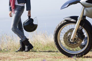 Woman motorcyclist on countryside
