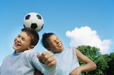 Boys (10-12) playing football