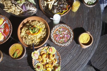 Platters of grilled fish, fried yucca, salad and fresh fruit