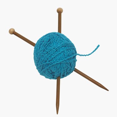 Ball of yarn and knitting needles