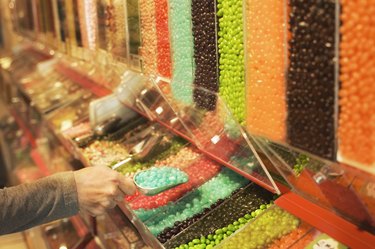 Woman scooping jelly beans in candy store
