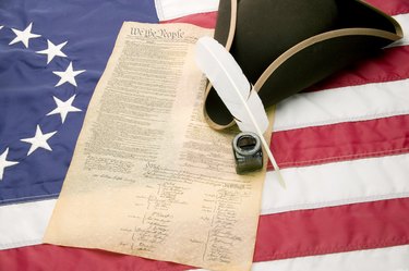 Tri-cornered hat, United States Constitution and 13-star American flag