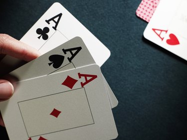 Man holding three aces, close-up