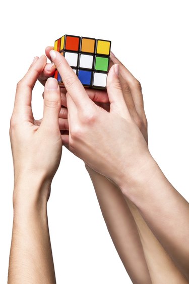 Hands holding color cube