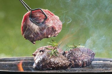 Grilled beef steaks on fire